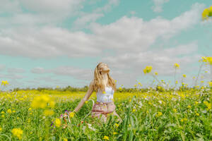 Young woman in a flower meadow in spring - ERRF02894