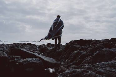 Rear view of man standing at the coast, Sao Miguel Island, Azores, Portugal - AFVF05829