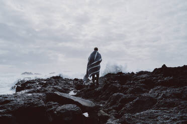 Rear view of man standing at the coast, Sao Miguel Island, Azores, Portugal - AFVF05830