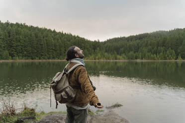 Man standing at lakeshore, Sao Miguel Island, Azores, Portugal - AFVF05839