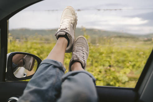 Woman's feet leaning out of car window - JPIF00579