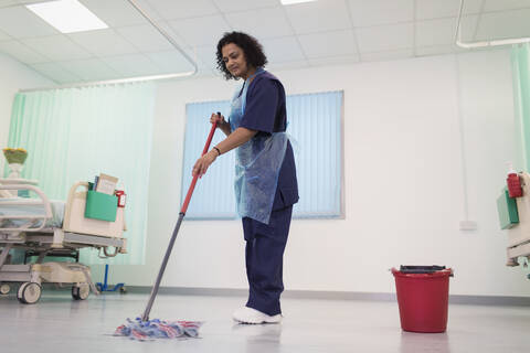 Female orderly mopping hospital ward floor stock photo