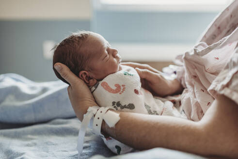 Side view of newborn boy profile with hat in hospital - CAVF77667