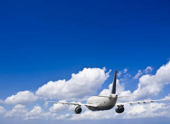 Civil airliner in a blue sky with some clouds - CAVF77733