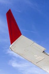 Wing tip of modern civil jet airliner against blue sky - CAVF77737