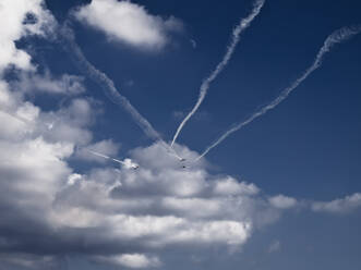 Mono propeller aircraft squadron flying in formation into a cloudy sky - CAVF77761