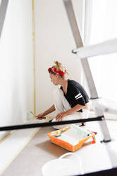 Girl paints the walls in the house - CAVF77764