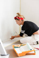 Girl paints the walls in the house - CAVF77765