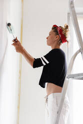 Girl paints the walls in the house - CAVF77766