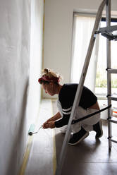 Girl paints the walls in the house - CAVF77767