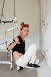 Girl paints the walls in the house - CAVF77769