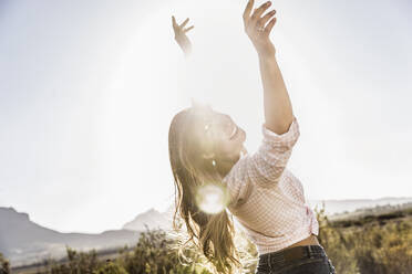 Long-haired woman dancing in the countryside at sunset - SDAHF00690