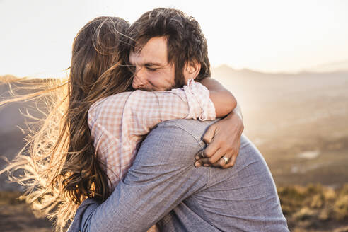 Affectionate couple hugging in the countryside at sunset - SDAHF00717