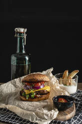 Studio shot of ready-to-eat hamburger with red bell pepper, onions and cheese - VPIF02173