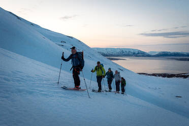 Group ski touring in Iceland during sunrise - CAVF77814