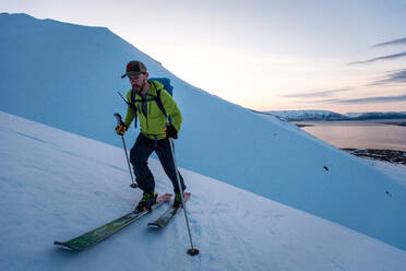 Mann beim Skilanglauf in Island bei Sonnenaufgang - CAVF77816