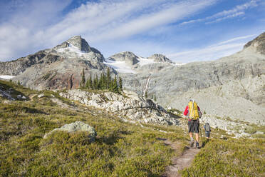Rear view of backpackers approaching Locomotive Mountain. - CAVF77967