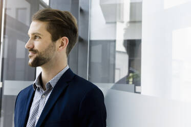 Portrait of bearded young businessman looking at distance - BMOF00343