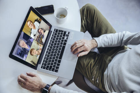 Man having a conference call at home, using laptop - MFF05161