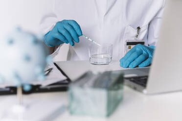 Close-up of scientist using lateral flow device at desk - MFF05195