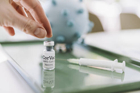 Hand with Corona virus vaccine dose - MFF05230