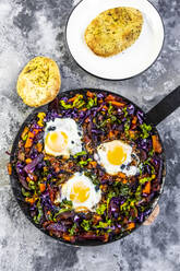 Pan of beetroot shakshouka with chard, carrots, tomatoes, red cabbage and pita bread - SARF04504