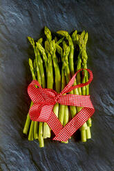 Fresh green asparagus bundle with red bow - JTF01502