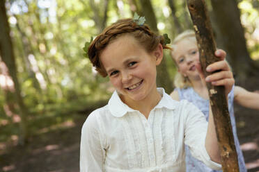 Portrait of smiling girl in forest with friend - AUF00213