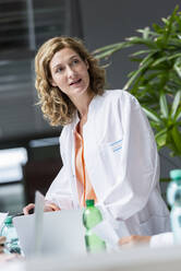 Portrait of female doctor in a meeting in conference room - BMOF00375