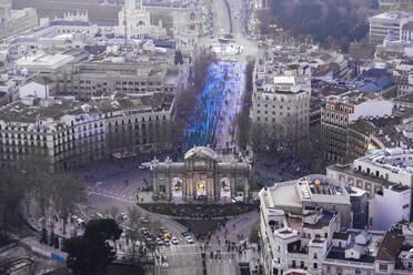 Spain, Madrid, Helicopter view of Puerta de Alcala and crowd of people participating in San Silvestre Vallecana marathon - JCMF00516