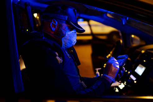 Polizist auf Notfalleinsatz, sitzt im Auto und macht Notizen - OCMF01161