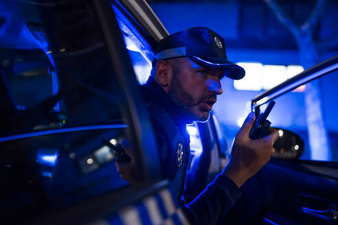 Policeman on emergency mission, using phone - OCMF01165