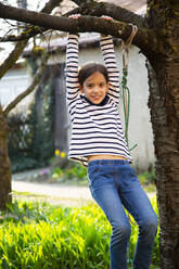 Portrait of smiling girl playing in garden - LVF08726