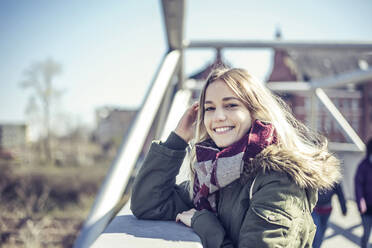 Portrait of smiling young woman on a bridge in the city - BFRF02215