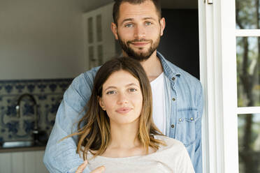 Portrait of attractive young couple in the door at home - SBOF02209