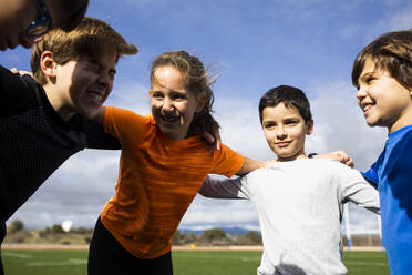 Children cheering themselves before running a race - ABZF03079