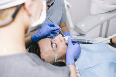 Man receiving dental treatment - DGOF00609