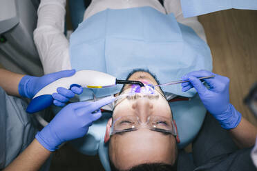 Man receiving dental treatment - DGOF00617