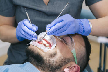 Man receiving dental treatment - DGOF00621