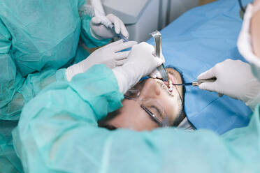 Man receiving dental treatment - DGOF00628