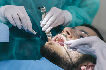 Portrait of man receiving dental treatment - DGOF00633