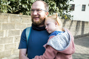 Portrait of happy father carrying his little daughter - IHF00315