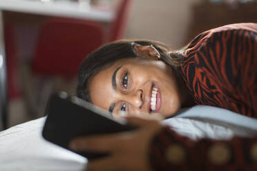 Smiling, happy teenage girl using smart phone - CAIF24917
