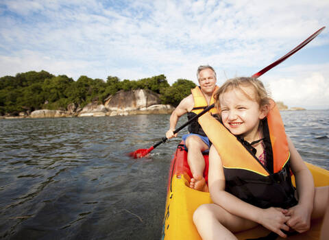 Father and daughter canoeing together, Koh Samui, Thailand stock photo