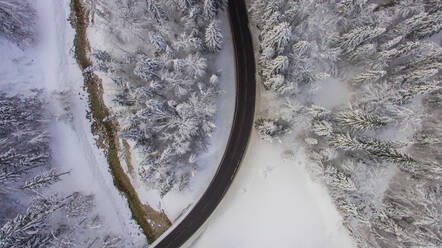 Aerial view of the road and winter landscape near the famous tourist attraction - Hallstat in Austria. - AAEF07306