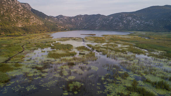 Luftaufnahme der Landschaft des Kuti-Sees im Neretva-Tal. Einigen Legenden zufolge ist das antike Troja unter diesem See begraben, der sich in der Nähe der Stadt Opuzen in Dalmatien, Kroatien, befindet. - AAEF07590