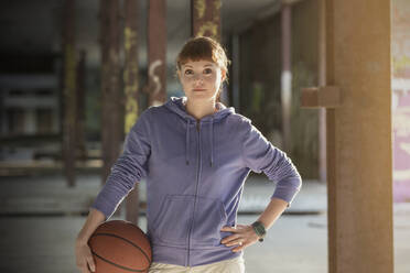 Portrait confident young woman with basketball - CAIF25179