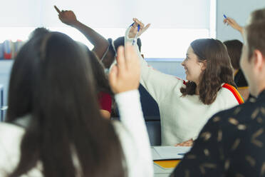 Gymnasiasten mit erhobenen Händen im Klassenzimmer - CAIF25274