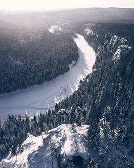 Aerial view of the top above frozen Usva River in winter forest in middle Ural, Perm Krai, Russia. - AAEF07767
