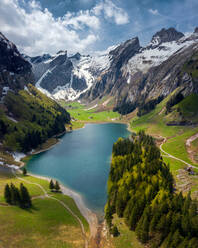 Aerial view of the Seealpsee lake surrounded with mountains in canton of Appenzell, Innerrhoden, Switzerland, - AAEF07894